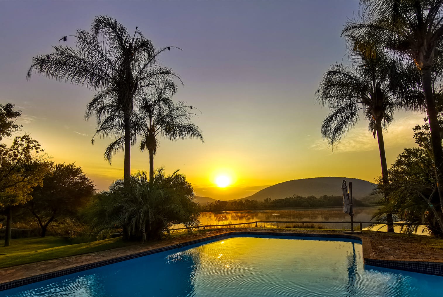 Hippo Lakes Safari lodge swimming pool with sunrise