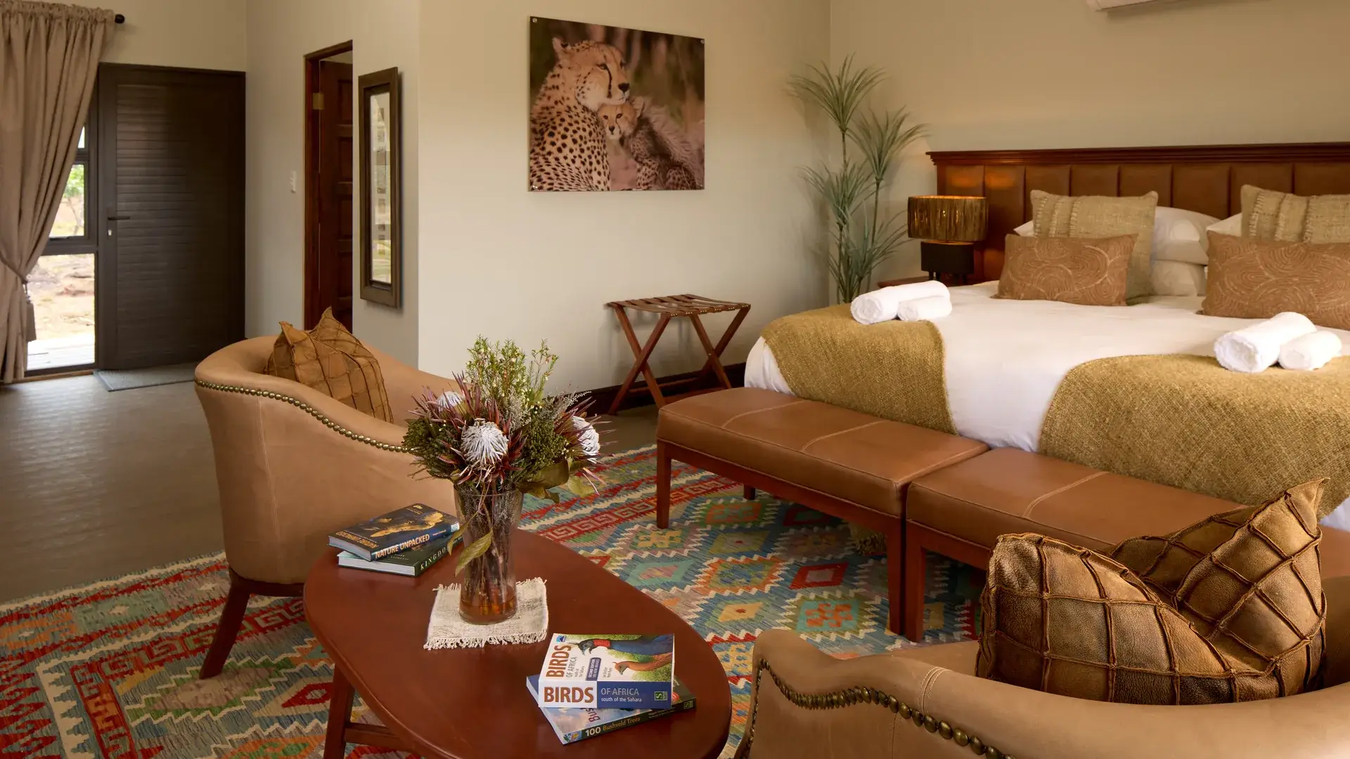 Lounge area and bed in an Impala tent